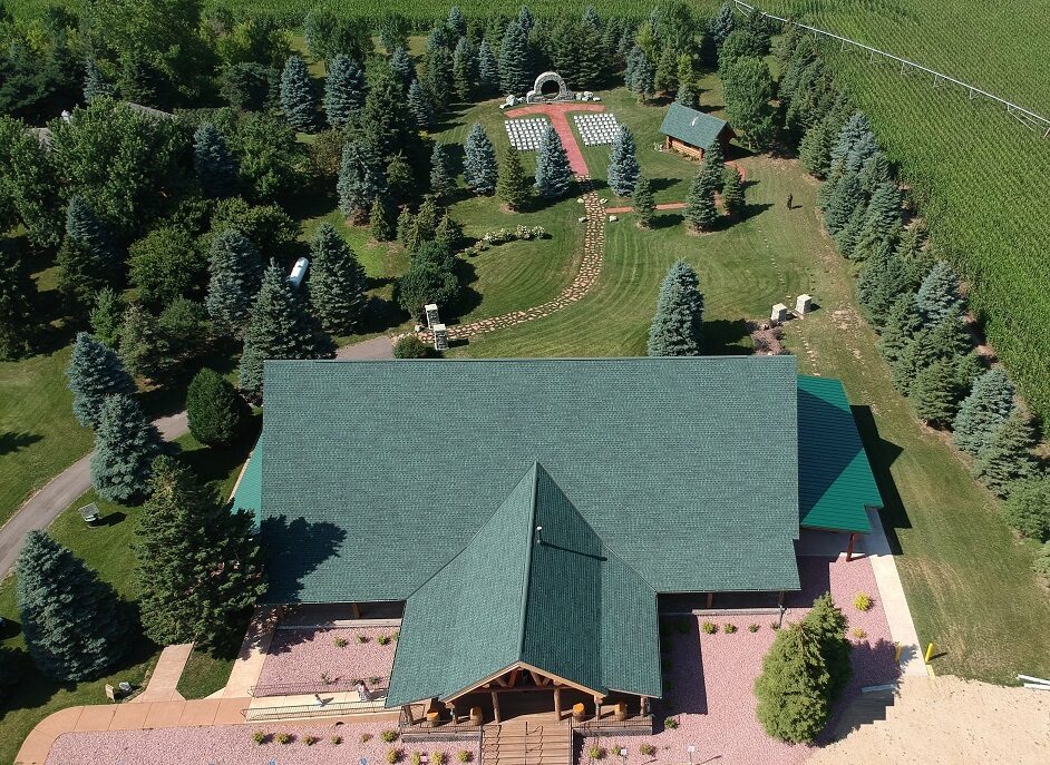 Aerial view of the Glenhaven Events building, wedding garden, and grounds surrounded by farm fields in Farmington MN
